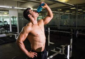man drinks water gym